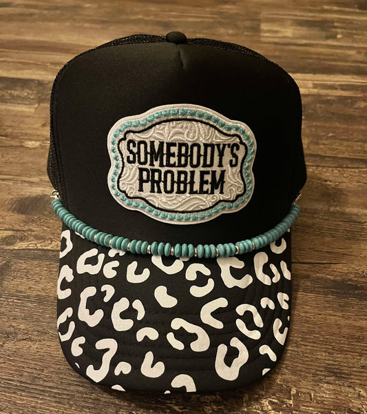 SOMEBODY'S PROBLEM CHEETAH BRIM TRUCKER HAT